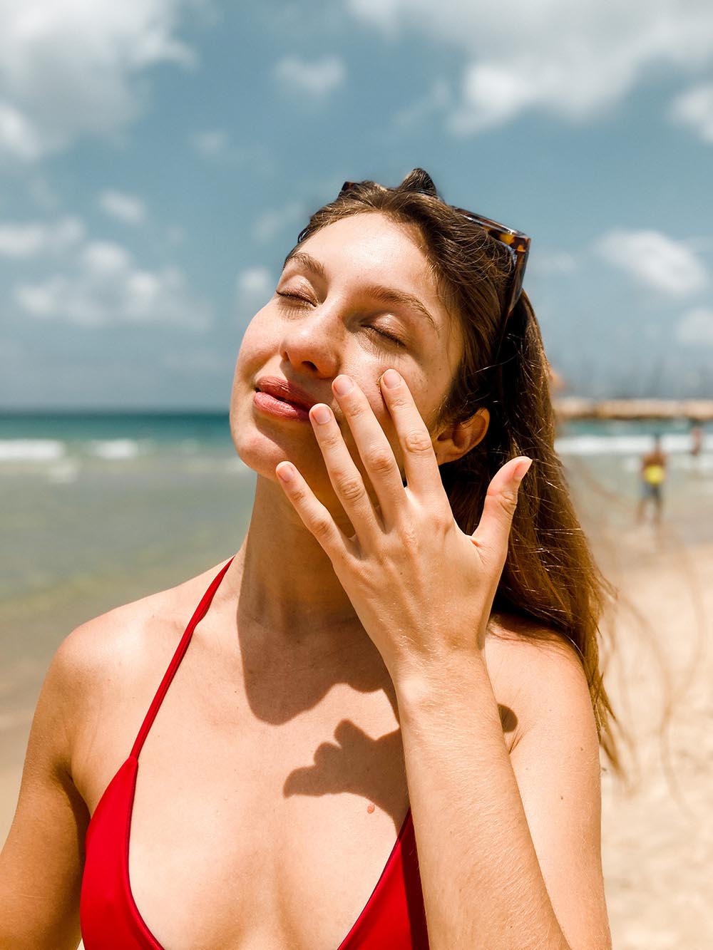 Cute girl putting on mineral sunscreen